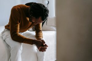 Bored Man Sitting on Bed