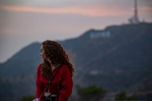 Woman Sitting in front of Hollywood Sign