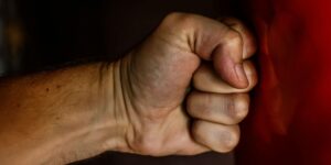 A close-up shot of a clenched fist, symbolizing anger, aggression, or determination.