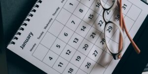 calendar page with reading glasses resting on dates