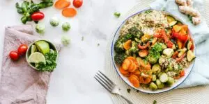 Colorful bowl of quinoa and roasted vegetables with fresh herbs, representing the role of balanced, whole-food nutrition in holistic rehab and long-term recovery.