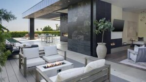 A luxurious outdoor lounge area at a private Malibu rehabilitation center, featuring modern seating, a fire pit, and open-air architecture with coastal views, illustrating the serene and healing environment of beachside addiction treatment.