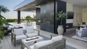 A luxurious outdoor lounge area at a private Malibu rehabilitation center, featuring modern seating, a fire pit, and open-air architecture with coastal views, illustrating the serene and healing environment of beachside addiction treatment.