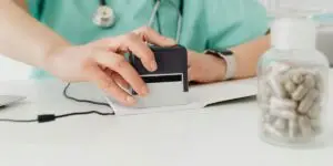 Healthcare worker processing a payment card at a medical office