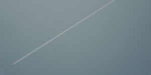 Plane flying overhead. Leaving behing a white trail.